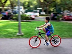 Boy is cycling on the road