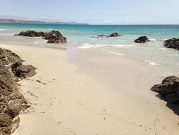 sandy beach with stones on sky background