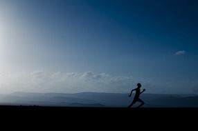 Lonely runner on the misty mountain road