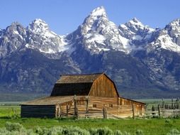 wooden shed at the foot of the cliffs in a national park in wyoming