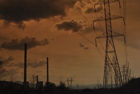 poles with power lines at dusk