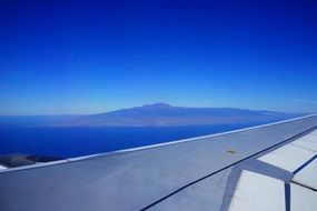 aircraft wing in view of scenic island in sea, spain, canary islands, tenerife