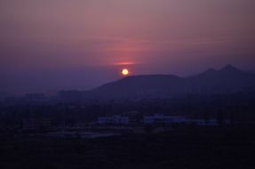 orange sun in the mountains in the evening