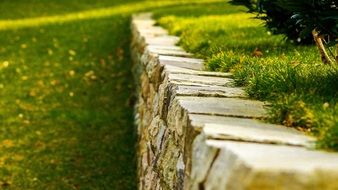 Grass at aged stone wall