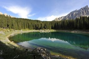 Beautiful lake among the green trees and mountains in val di fassa valley, Italy