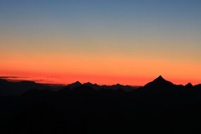 beautiful silhouette of mountains on a background of red sunset
