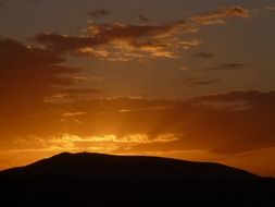 mountains in the background of a golden sunset