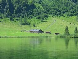 Cabin in a green meadow near the lake