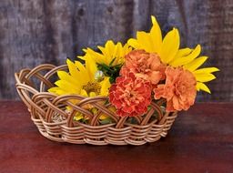 flowers in a wooden basket on the table