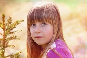 blond child face close-up on blurred background