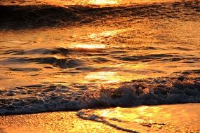 ocean surf in orange sunset