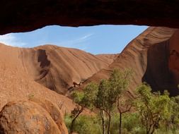 Uluru is a massive orange-brown rock of oval shape