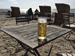 beer on a north sea beach on a sunny day