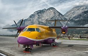 plane in airport at mountains, austria, innsbruck