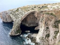 photo of caves on the ocean coast