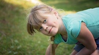 Little girl half sitting on the lawn