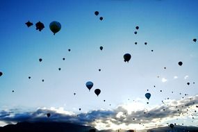 Flight of balloons under the blue sky