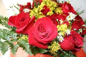 red roses with tiny flowers and fern, bouquet