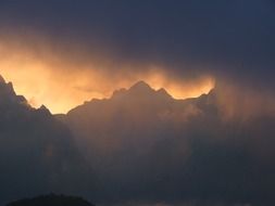 sunlight through foggy clouds over the Andes