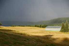 stormy sky over green field