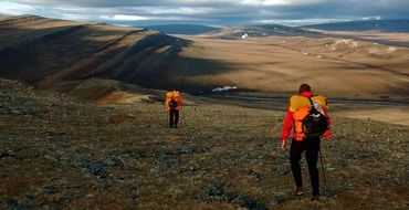 Men hiking alaska wilderness tundra mountains