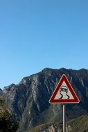 behind the road sign is a rock