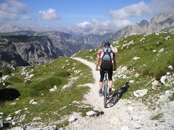 Sportsman cycling in the mountains on a sunny day