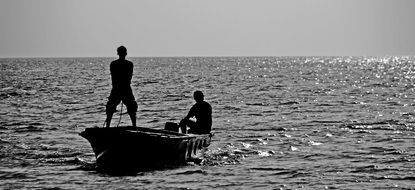 black and white photo of fishermen in a boat