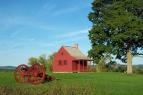 Red cannon and red wooden house in the countryside in Saratoga, NY