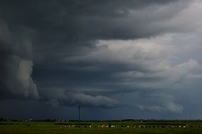 landscape of stormy dark gray clouds over the village