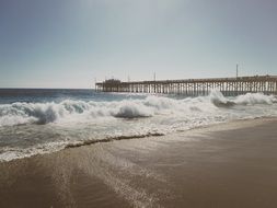 ocean pier on the beach in summertime