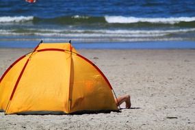 people in a yellow tent on the North Sea