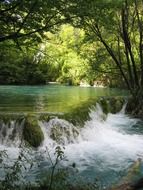 low waterfall in summer forest