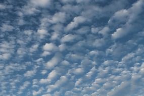 lot of small white clouds at blue sky