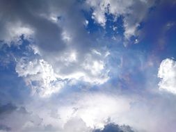clouds illuminated by the sun on the blue sky