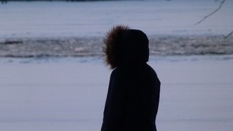 girl in a winter jacket on a background of a winter landscape