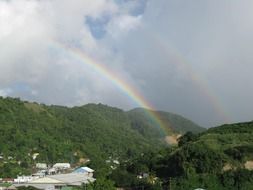 double rainbow over rural landscape