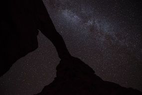 sandstone arch at the background of starry night sky