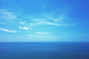 blue ocean water and light blue summer sky