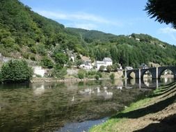 remote view of a bridge over a river in a france village