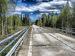 highway among nature in suomussalmi, finland