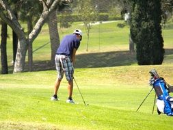 man resting and playing golf on the court