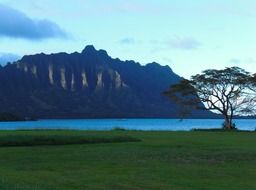 landscape of high mountains on a ocean bank at dusk