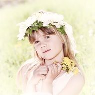 Blond girl with garland of white flowers on head