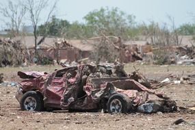 broken and rumpled car after tornado in Oklahoma