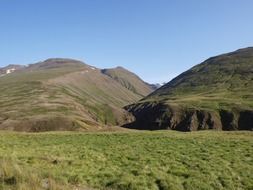 green hills on a sunny day in iceland