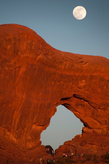 natural rock bridge on the background of the full moon