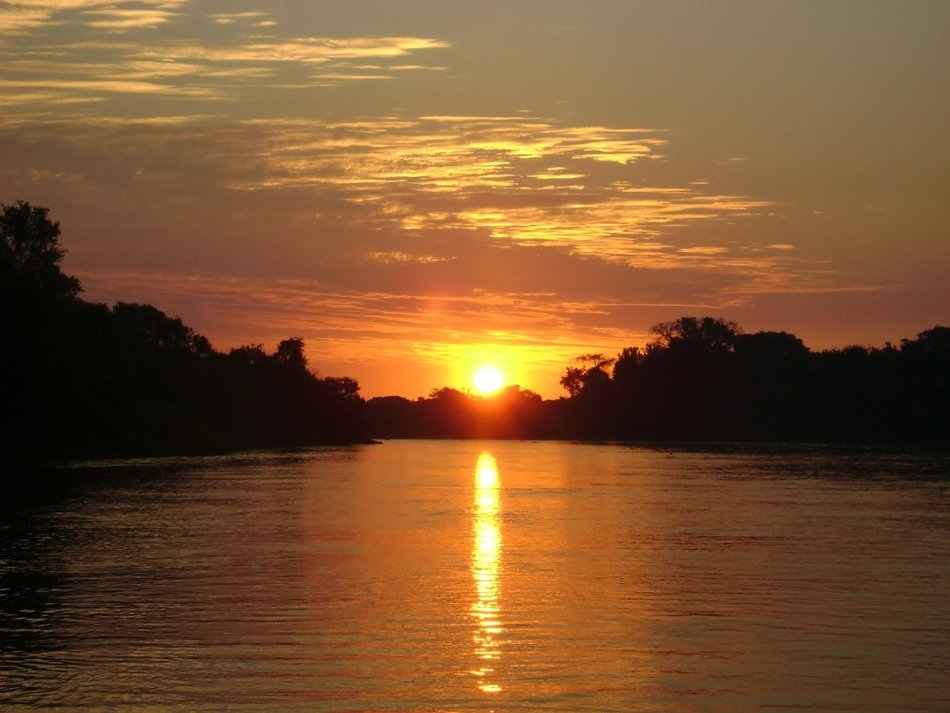 sunset over the lake among the forest