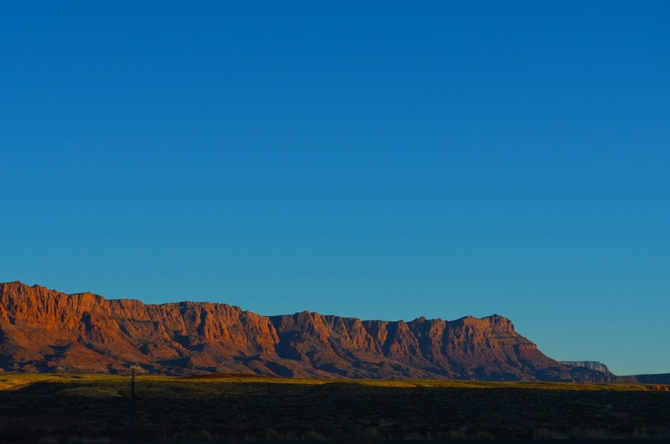 Valley against the background of mountains in the sunlight