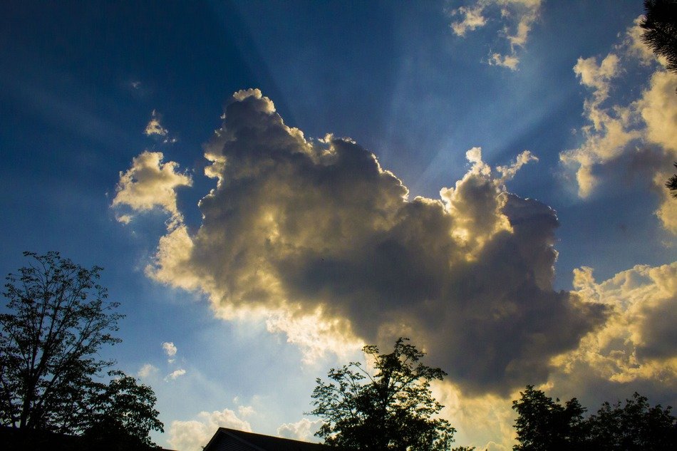 the sun's rays from behind the cloud